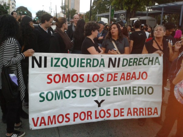 “Neither the left nor the right, we’re those from the bottom and the middle, and we’re coming for those at the top,” reads this banner. 