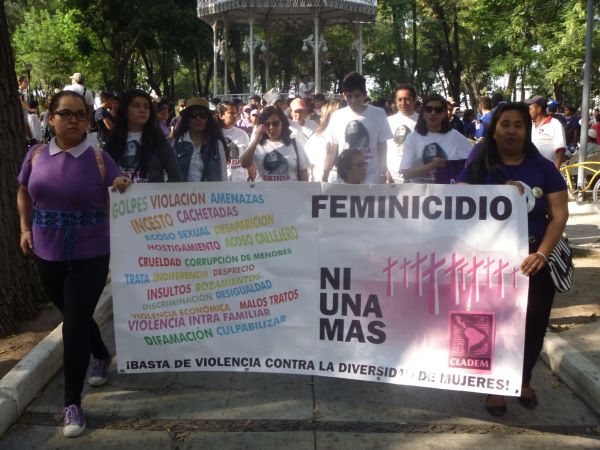 Protesters hold a sign up reading 'Not one more femicide' during a feminist march in Guadalajara 