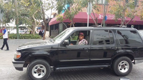 Some locals accuse parking attendants of extortion but others trust them with their car keys.