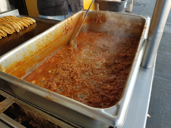 The barbacoa is made with shredded beef slowly braised with chiles and tomatoes. 