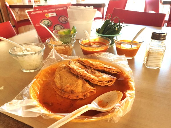 Most people at Tacos Charlie order their tacos “bañados”—literally bathed in sauce.